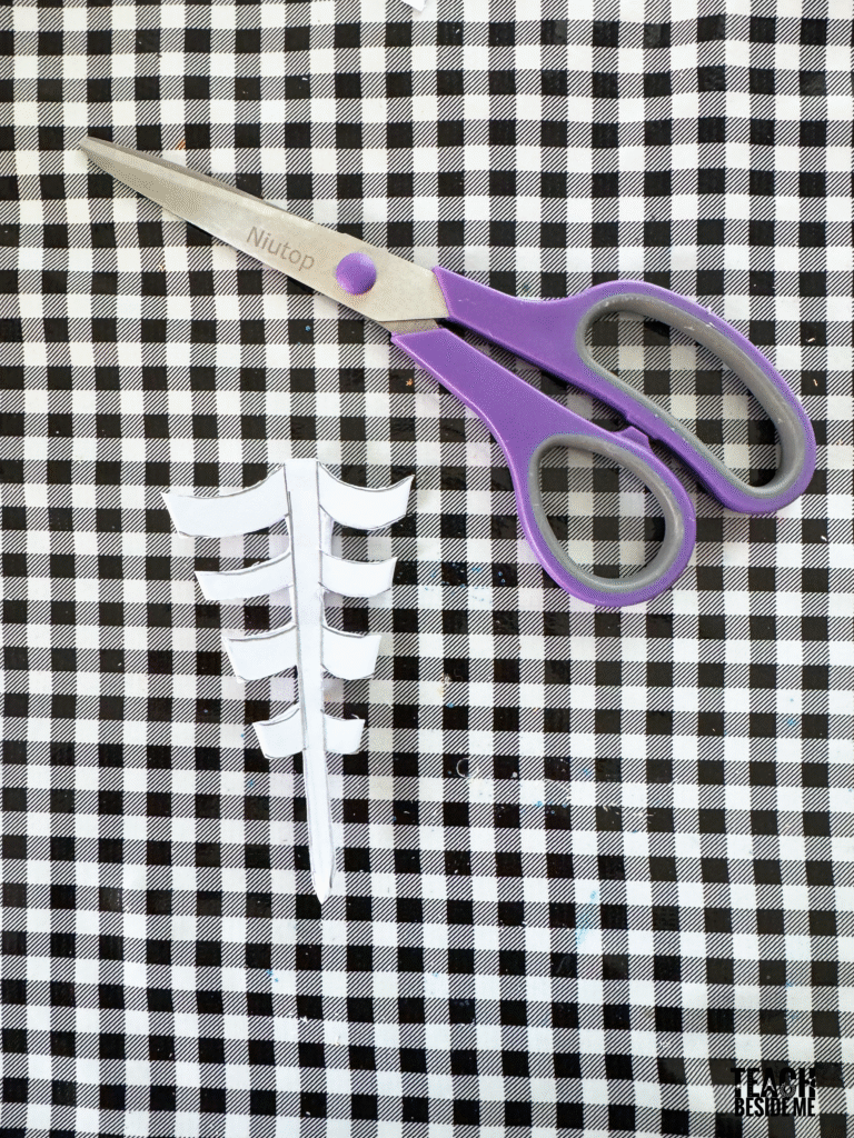 cutting a snowflake paper spiderweb